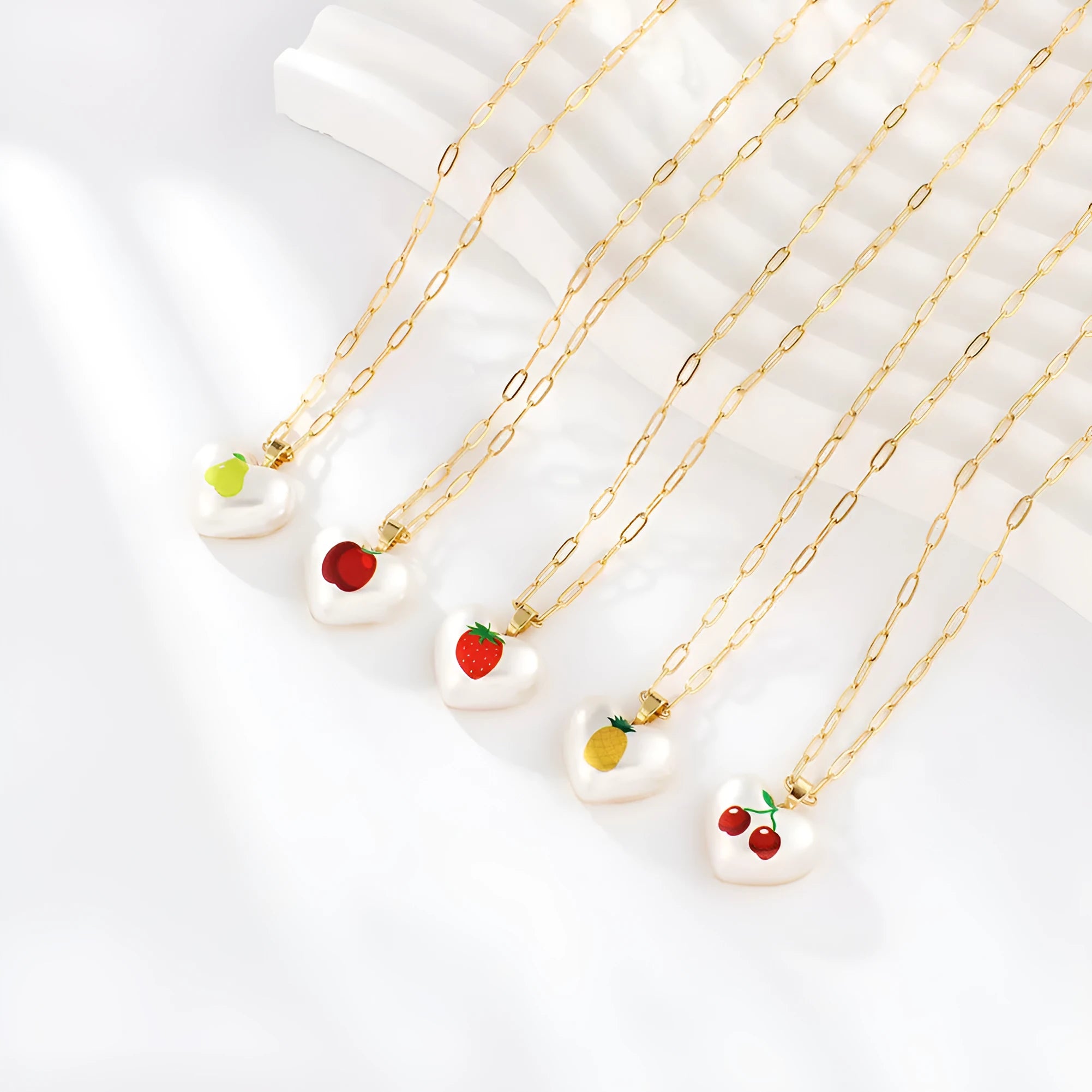 Heart-shaped necklace with a choice of fruit pendant charms on an adjustable chain.