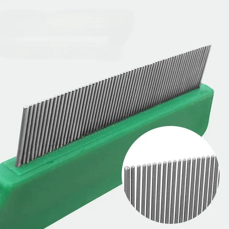 Green plastic handle stainless steel pet flea comb for dogs and cats on a white background.