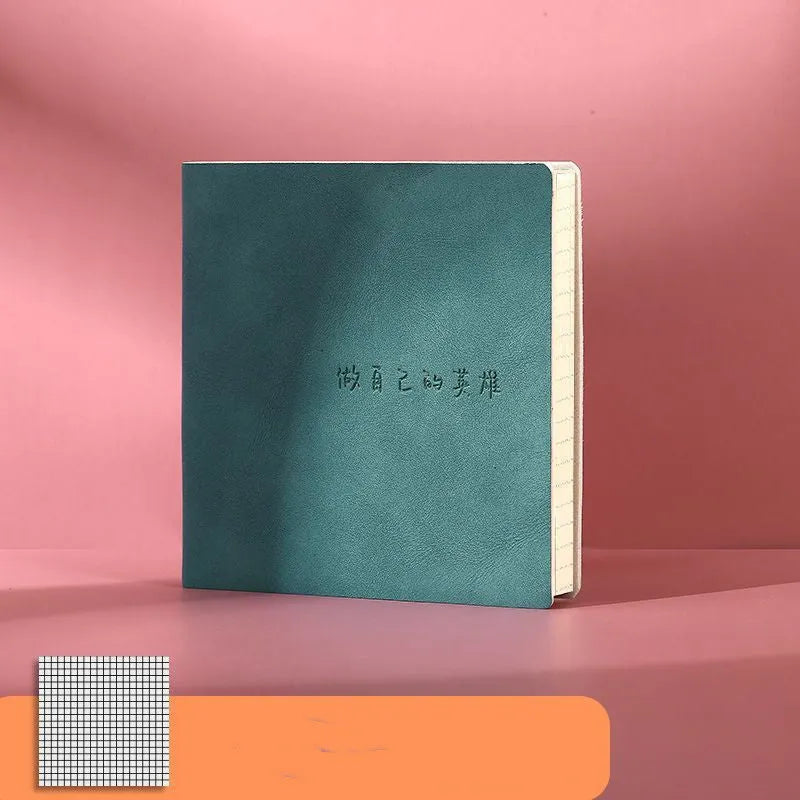 Square notebook with textured faux leather cover showing French fold binding and open blank pages