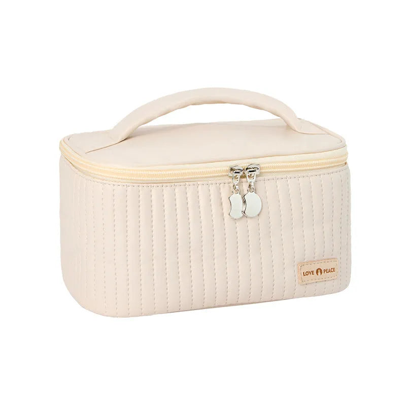 Open-top cake shaped makeup bag in solid colour PU leather, shown in a light blue colour variant.