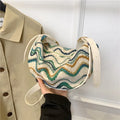 Women's woven straw crossbody bag showing internal phone and document compartments