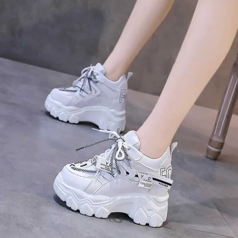 Women's white and black mesh platform sports shoes with cross-strap detail and rubber soles