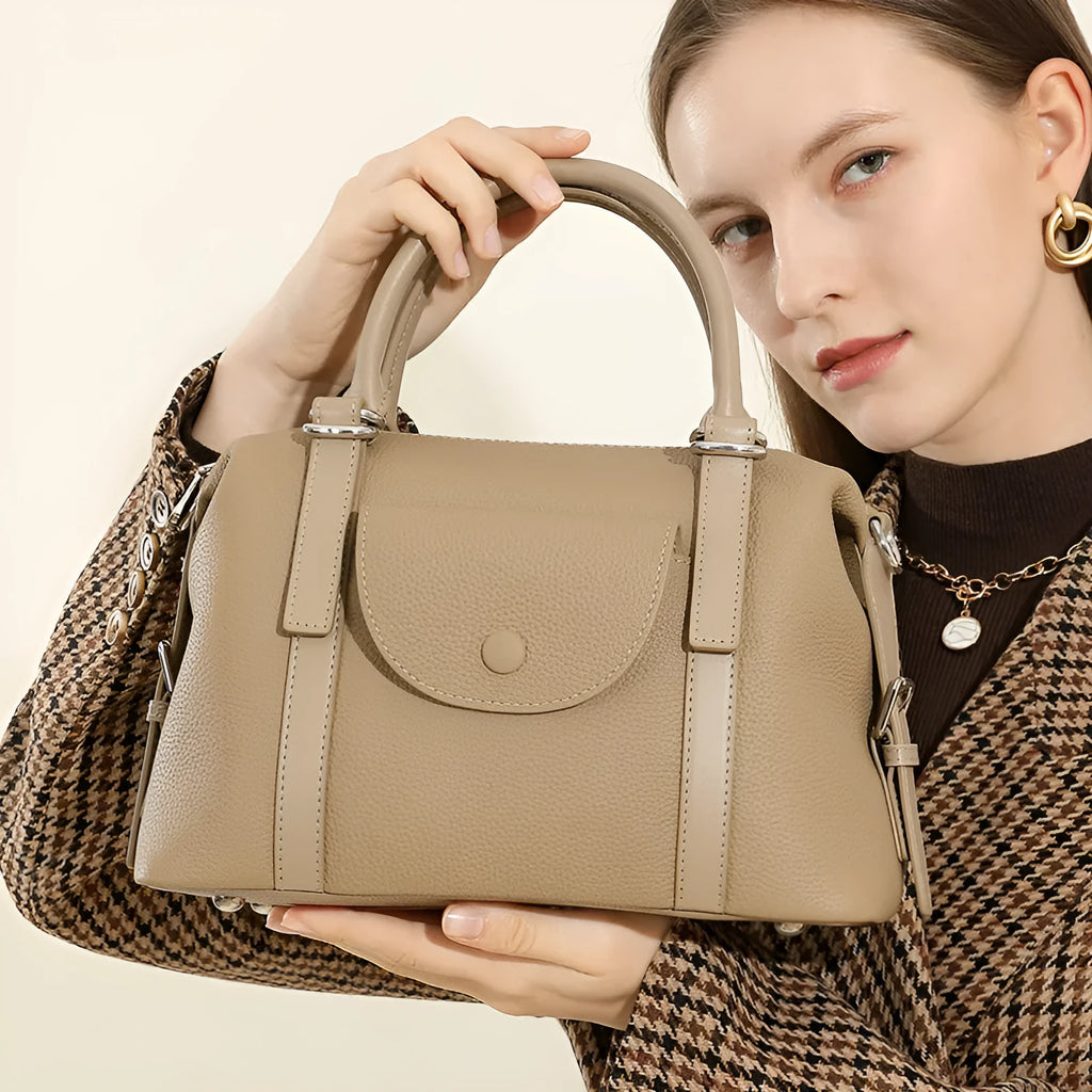 Genuine leather ladies handbag with contrast stitching and lock detail in street style