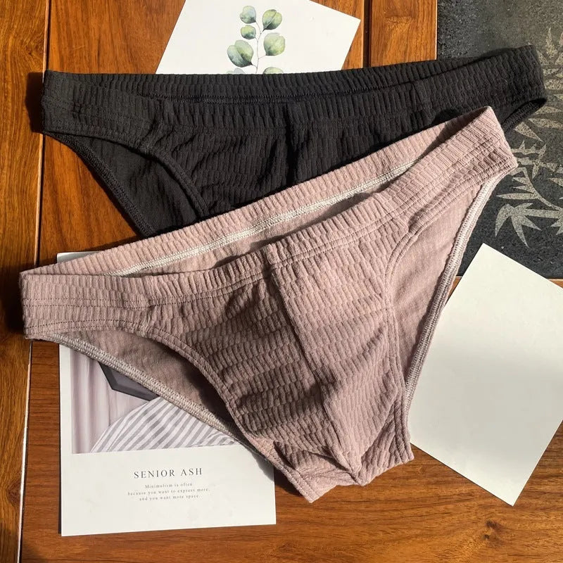 Men's solid colour cotton briefs with a mid waist and triangle design.