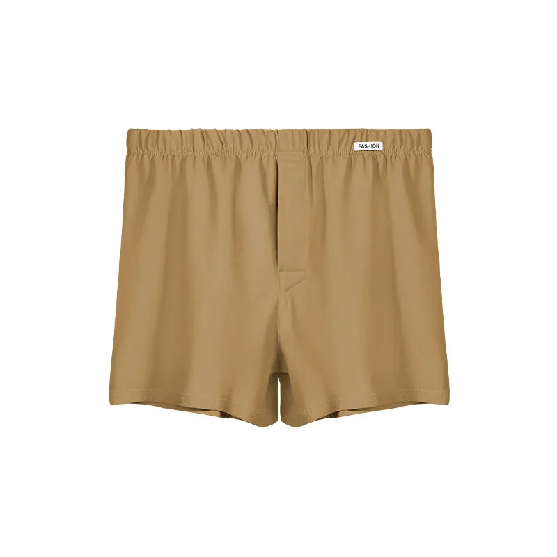 Men's loose-fitting cotton boxer shorts in a solid colour, shown in a light grey shade on a mid waist.