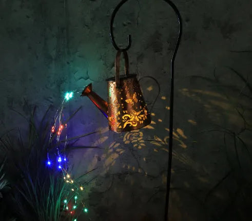 Iron solar garden lamp with tapered butterfly pattern and warm white LED lighting