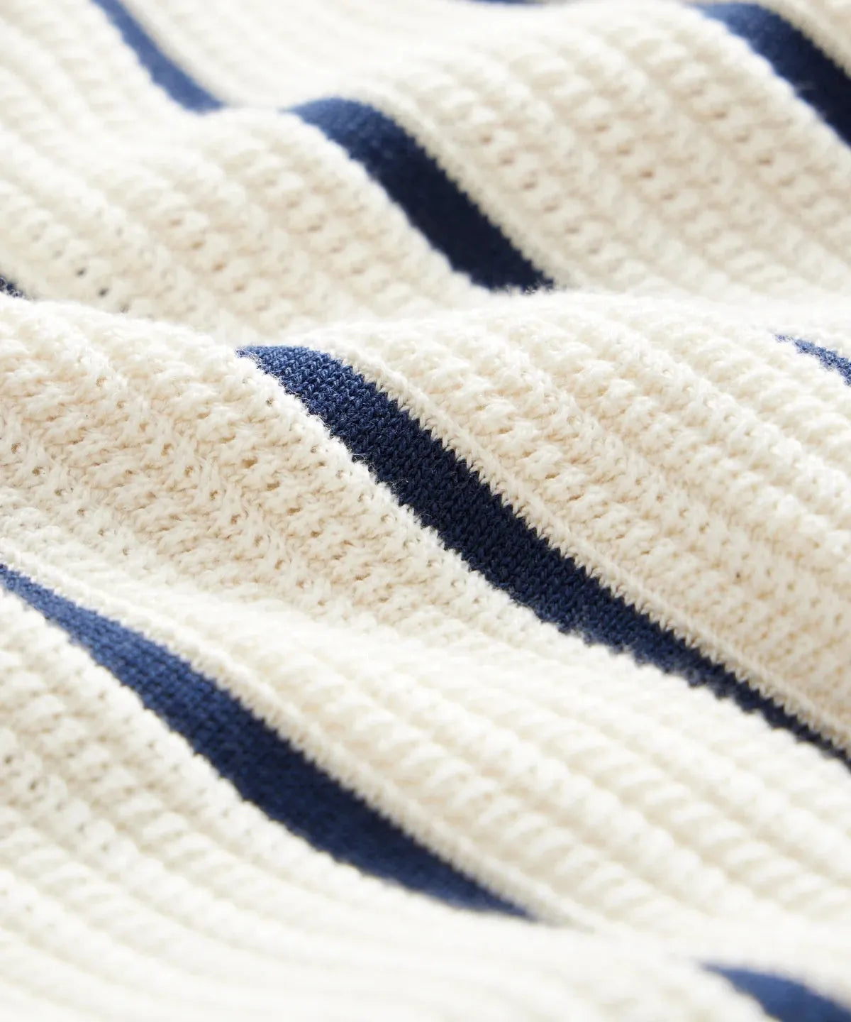 White men's knitted jumper with asymmetric design and striped pattern, featuring a lapel collar and short sleeves.