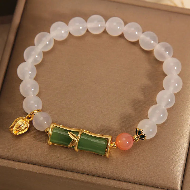 Women's white agate jasper bamboo bead bracelet with a single central jade focal bead.