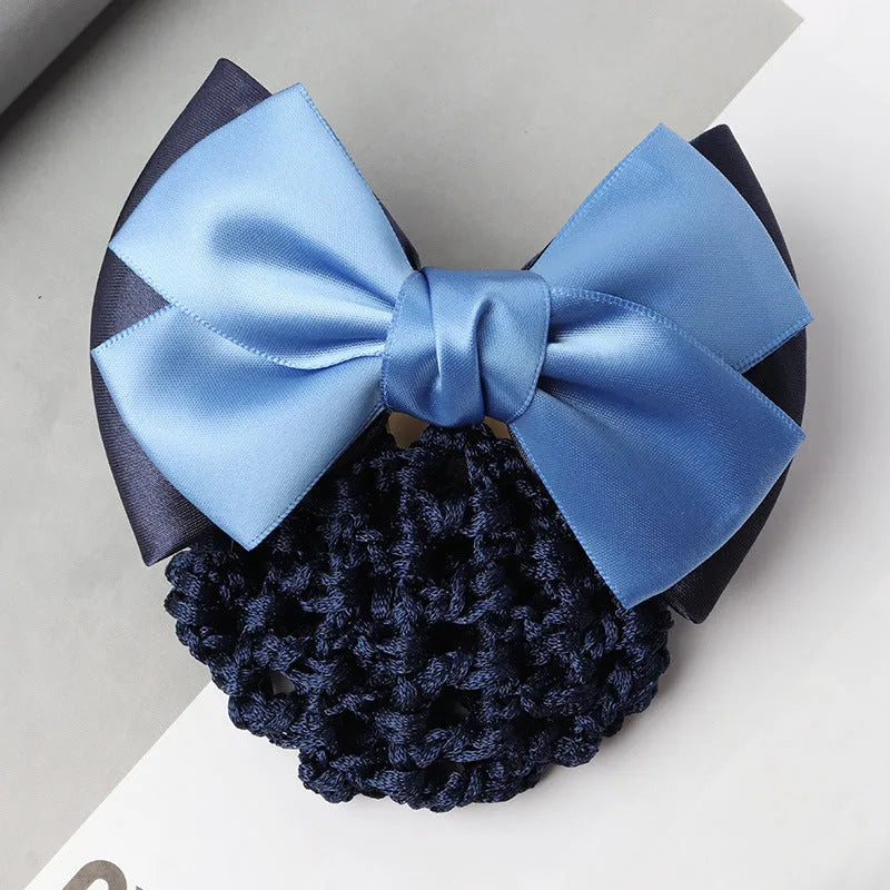Professional flower bow headdress hair clip ornament on a work plate, shown in a selection of net and mesh colour variations.
