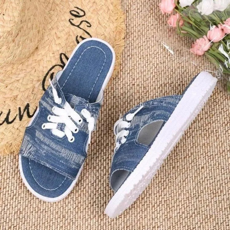 Blue women's flat Roman-style canvas slippers with cloth upper and rubber sole.