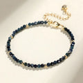 Close-up of a women's blue tourmaline gemstone beaded bracelet with 3mm beads and spacer design.