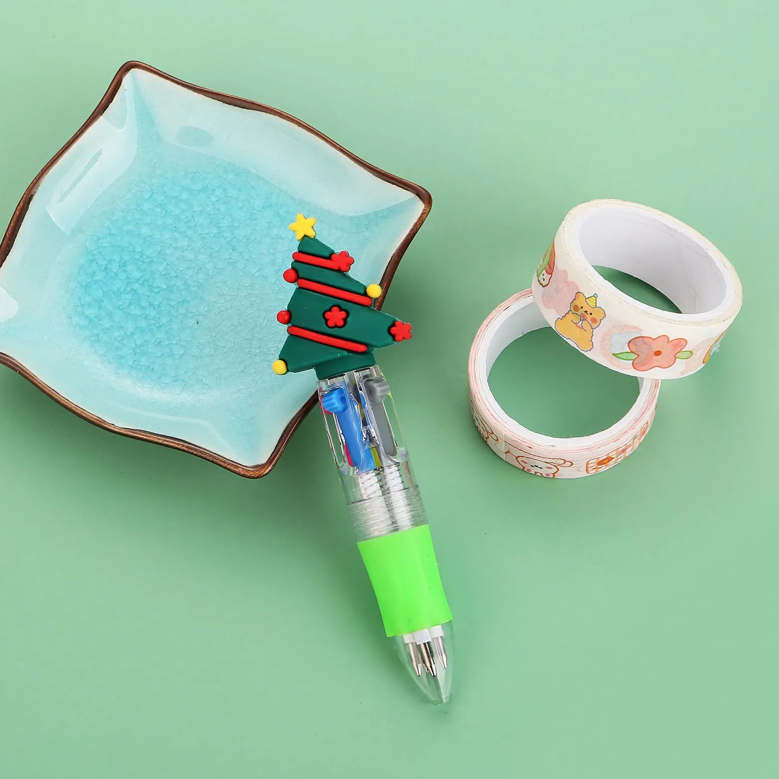 Compact 11cm Christmas four-colour press pen with festive designs including reindeer and snowmen.