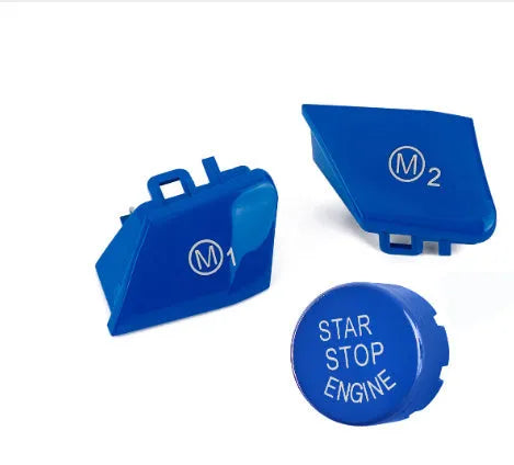 Pair of red and blue BMW M1 M2 steering wheel mode buttons with installation keys on a plain background.