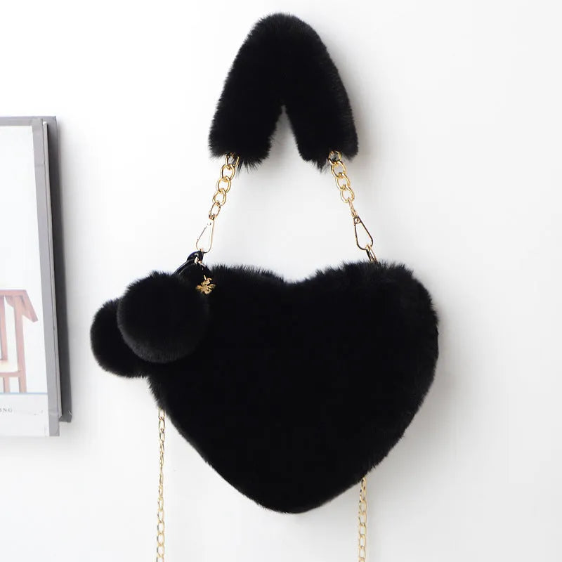Soft plush women's handbag in a red heart shape with a zipper and detachable strap.