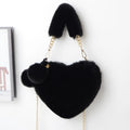 Soft plush women's handbag in a red heart shape with a zipper and detachable strap.