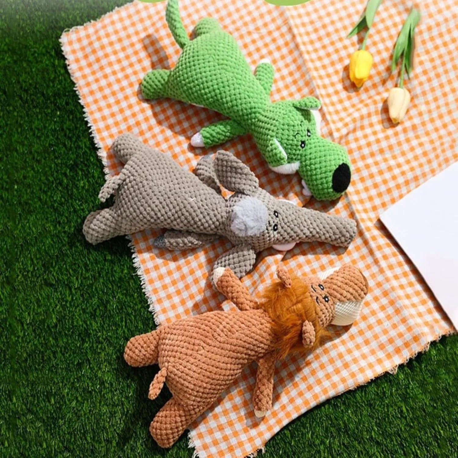 Four plush dog chew toys in green, grey and yellow with corn kernel texture design