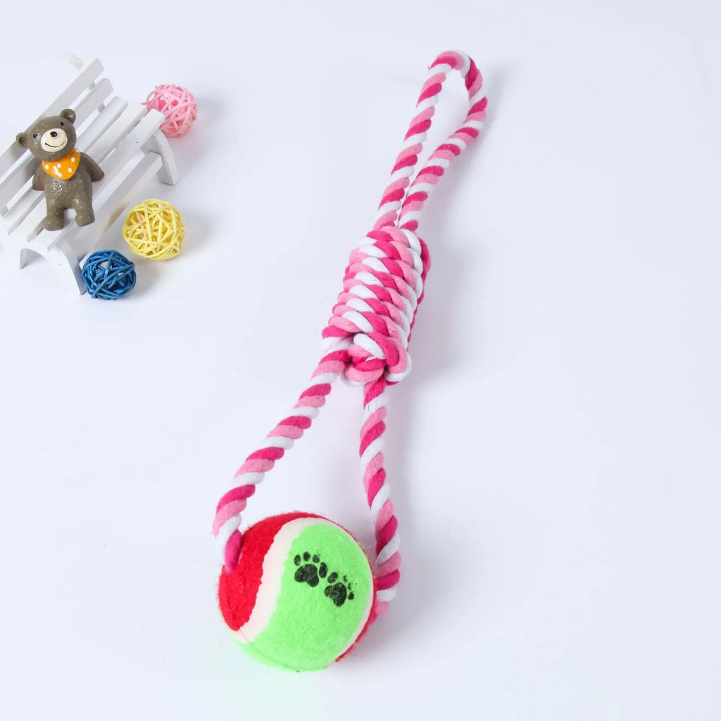 Braided red and white cotton rope dog tug toy for large breeds on a wooden floor.