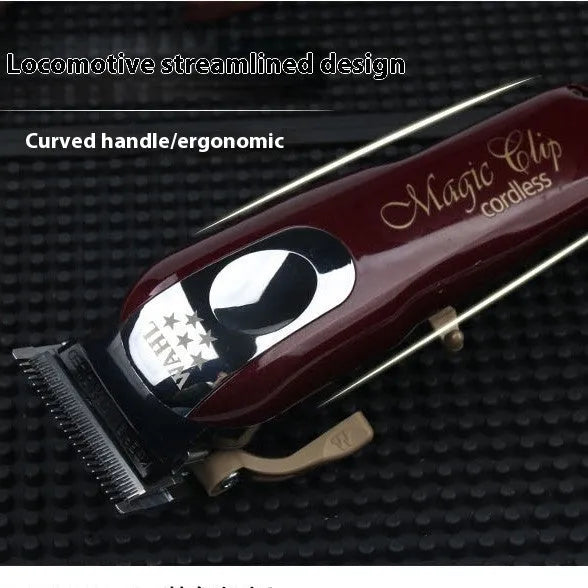 Cordless charging hair clipper set with stainless steel cutter head on a table.