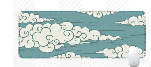 Large cloud pattern rubber desk mat with non-slip base on wooden desk surface