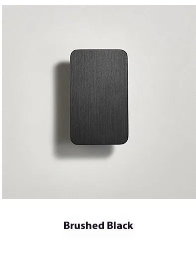 Minimalist Nordic-style LED wall lamp in black finish, mounted on a wall, showing clean lines and modern design.