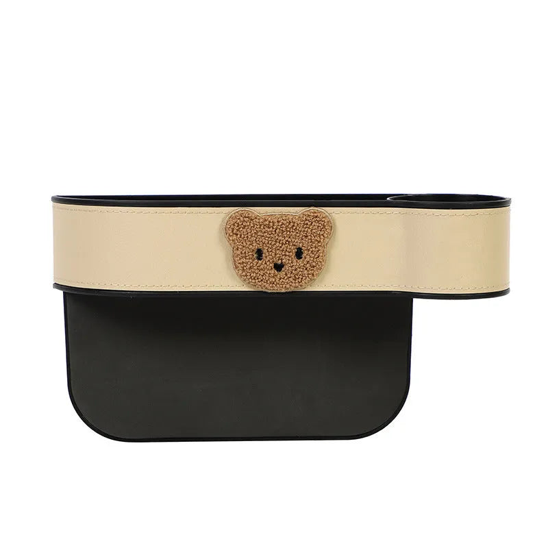 PU leather car seat gap storage box hanging between vehicle seats for small item organisation.