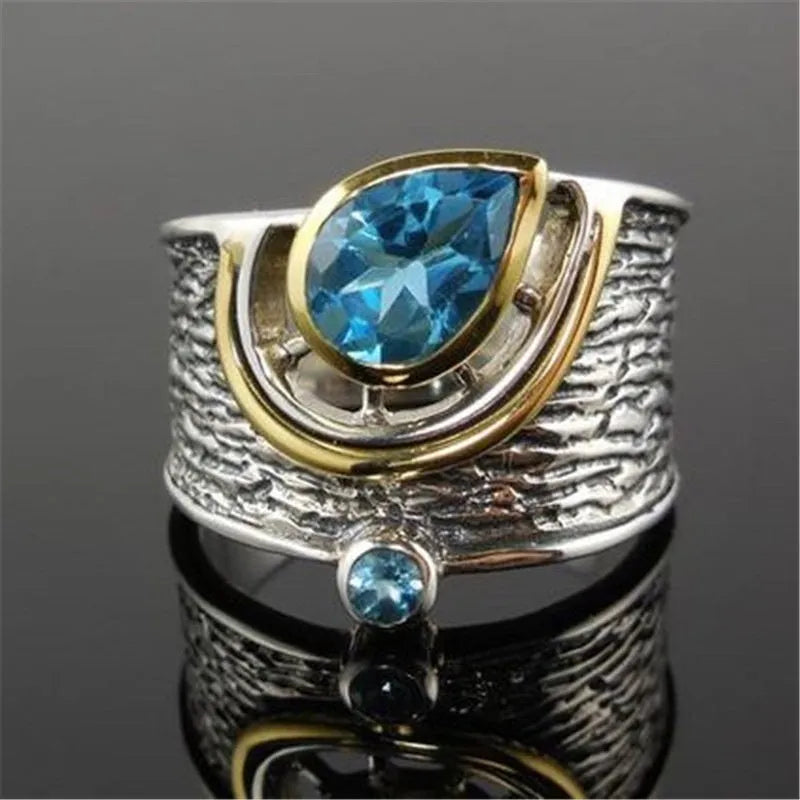 Blue drop-shaped zircon ring with rhinestone inlay on an alloy band, shown in women's sizes 6 to 10.