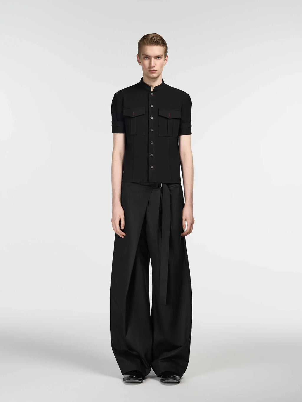 Black loose fit straight-leg trousers with adjustable waistband and single pleat detail