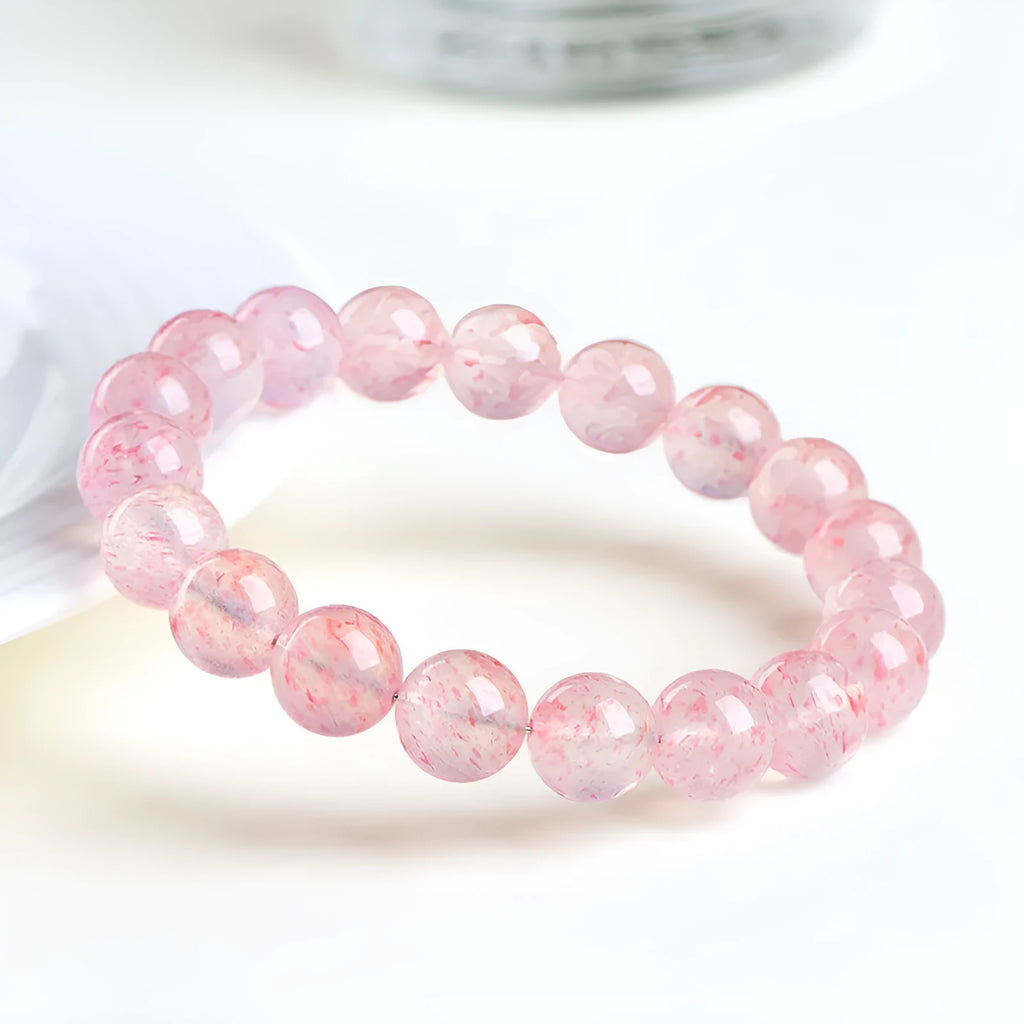 Natural white water strawberry quartz crystal bead bracelet with spherical 10mm beads on elastic.