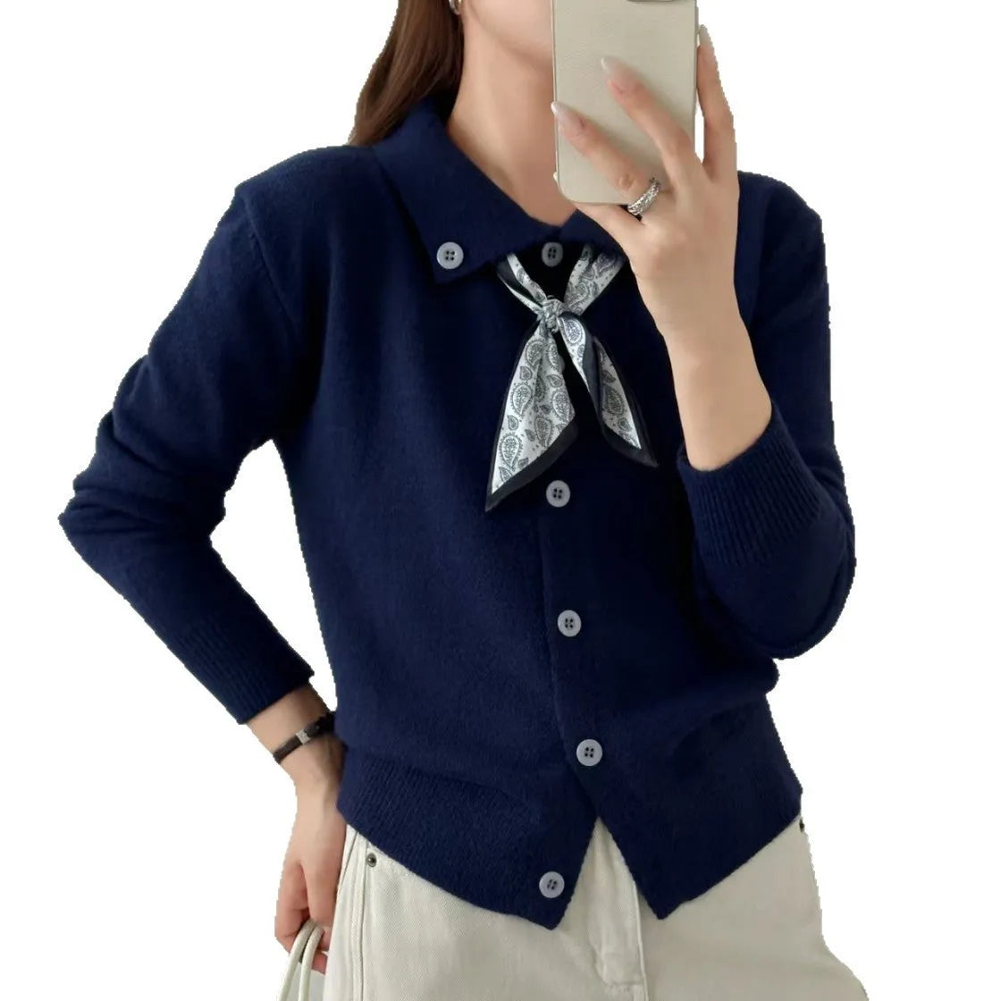 Beige cardigan sweater with attached lapel scarf and long sleeves on a model.