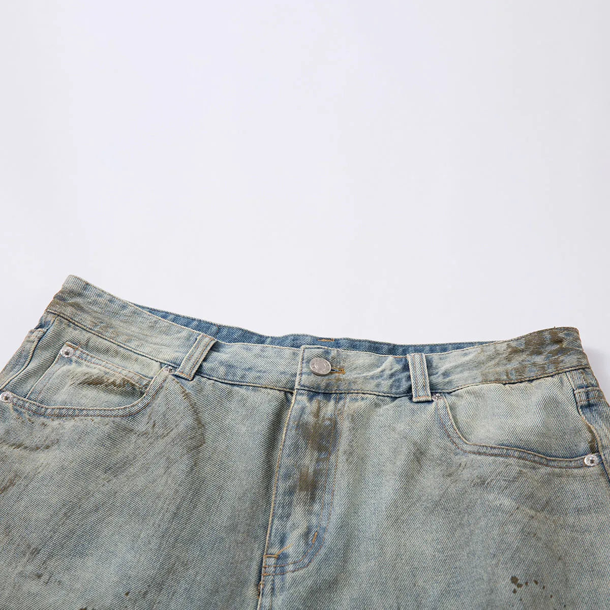 Blue washed cropped straight-leg denim jeans on a model, showing mid-length cut and street-fashion style.