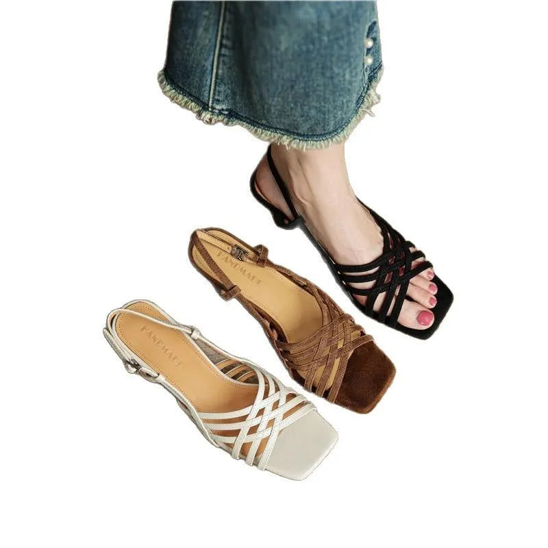 Retro women's sandals with thin cross straps, ankle buckle, and a mid heel on a square toe.