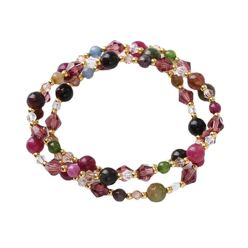 Three-ring crystal bracelet with tourmaline, strawberry quartz and amethyst stones on adjustable tightening rope