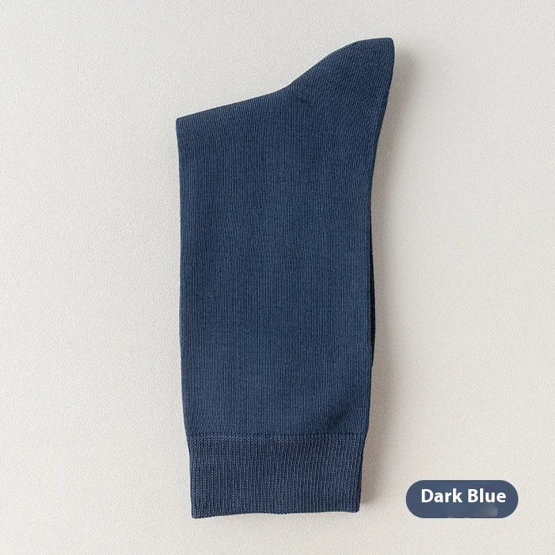Mid-calf men's socks in solid colours made from combed cotton, shown in a stack.
