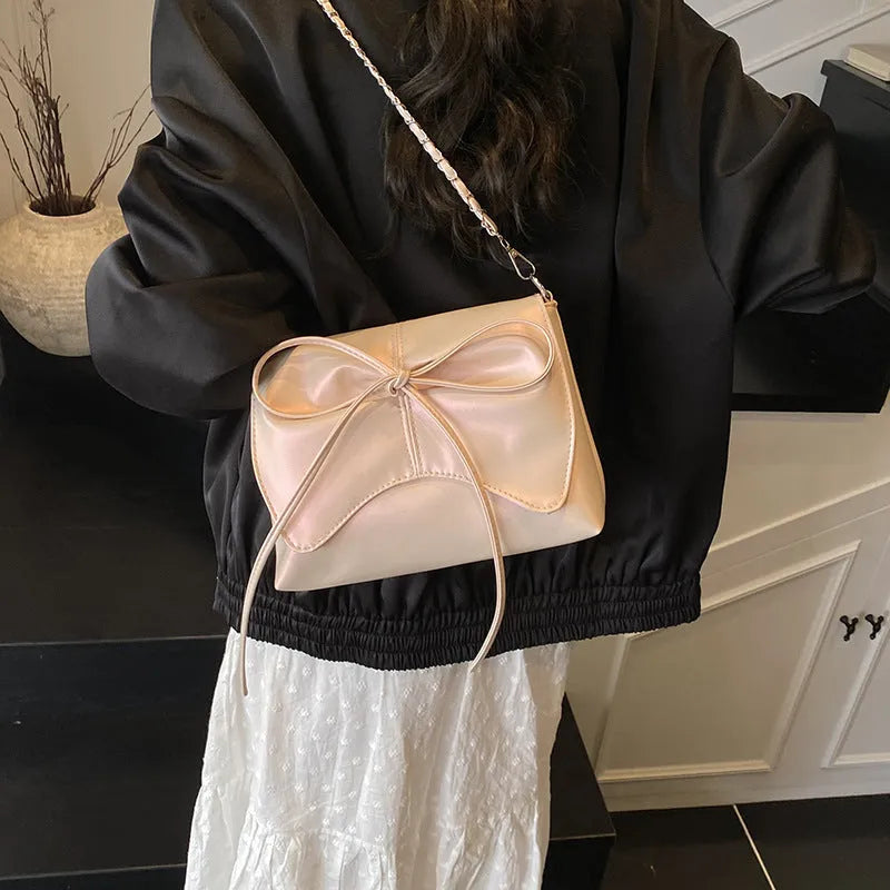Women's underarm crossbody bag in horizontal square shape with sewing line details and phone pocket