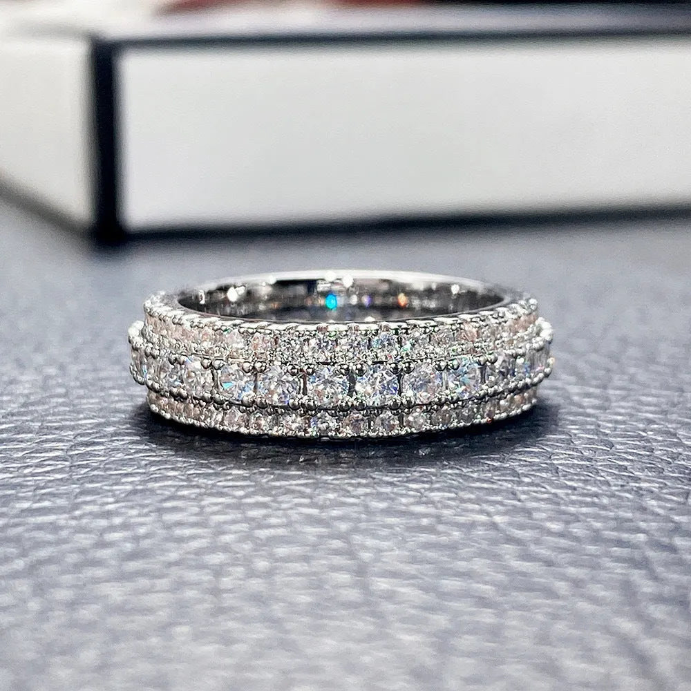 Geometric copper ring with triangular zircon inlay, shown in white gold plating.
