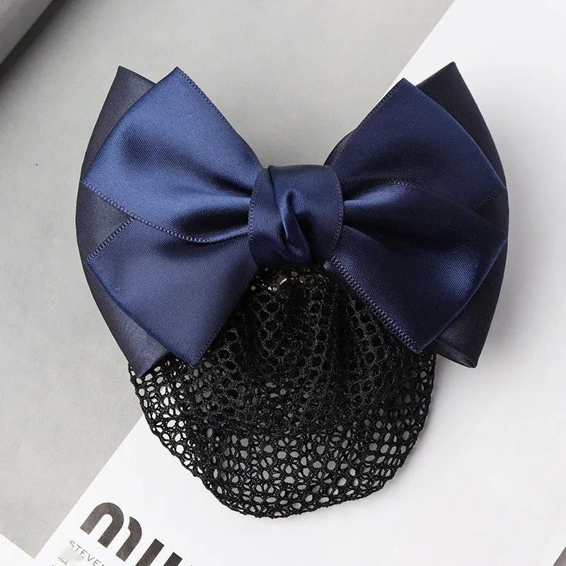 Professional flower bow headdress hair clip ornament on a work plate, shown in a selection of net and mesh colour variations.