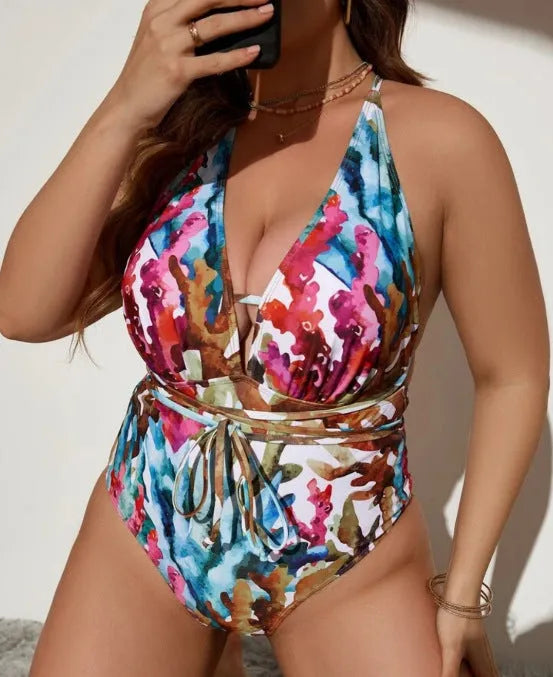 Women's solid purple one-piece halter swimsuit on a mannequin, showing briefs style cut.