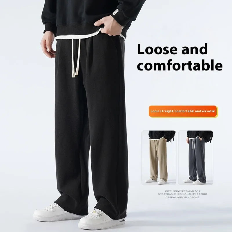 Men's thick apricot coloured fleece-lined loose fit casual sports trousers on a hanger.