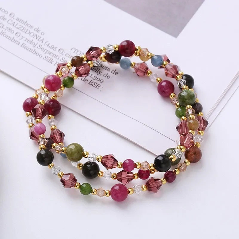 Three-ring crystal bracelet with tourmaline, strawberry quartz and amethyst stones on adjustable tightening rope