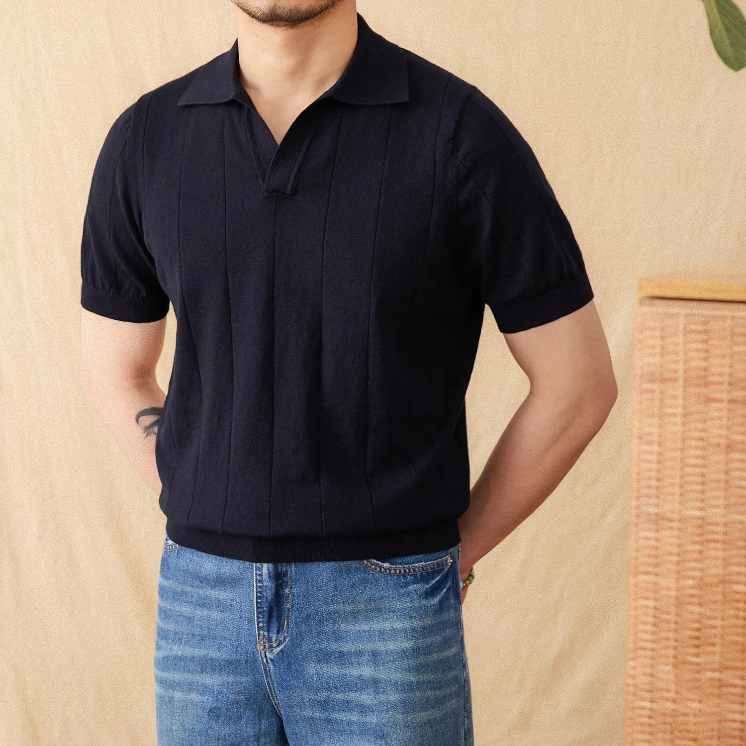 Man's purple short sleeve polo shirt with seagull collar and sunken stripe knitted texture.