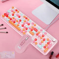 Macaron wired mechanical keyboard and green axis mouse set in rose red with USB cables on a desk