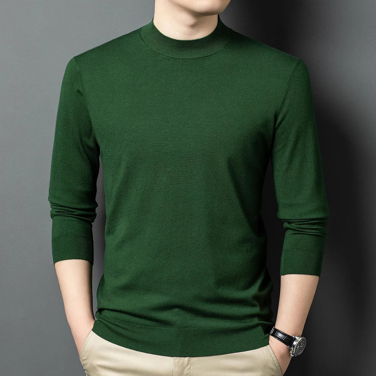Man wearing a round neck grey wool blend sweater with long sleeves.
