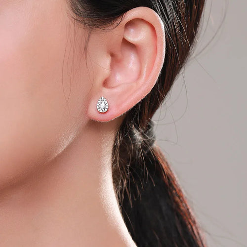 Close-up of a pair of polished silver water drop shaped ear studs on a 925 sterling silver post.