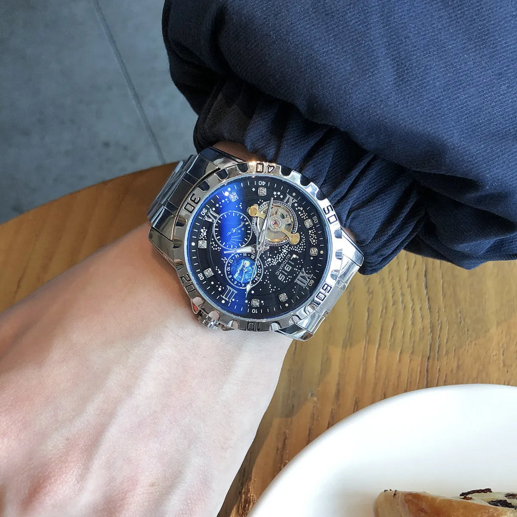 Men's silver automatic watch with black starry luminous dial on a steel bracelet