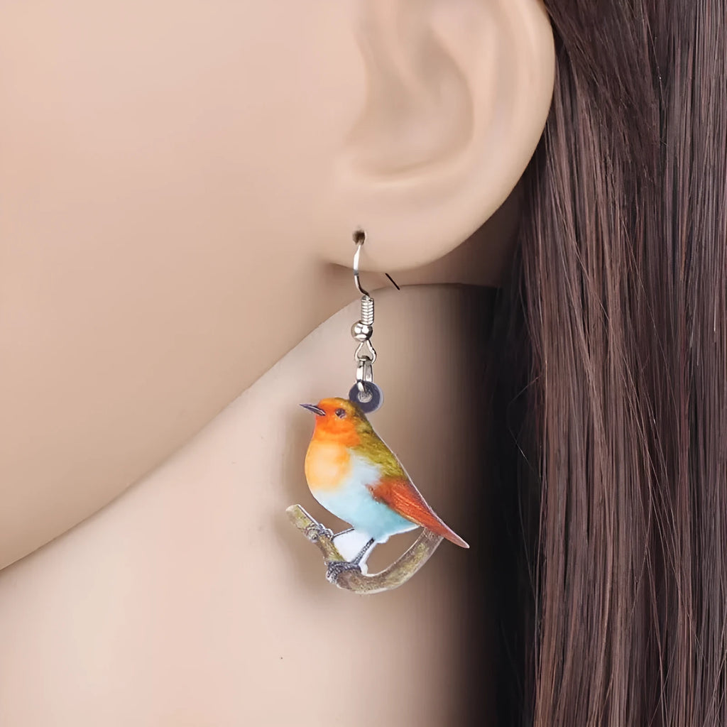 Acrylic blue titmouse pendant earrings with snake charm detail and printed animal design