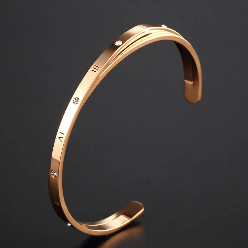 Open-ended women's bracelet in stainless steel with electroplated finish and inlaid zircon stones.