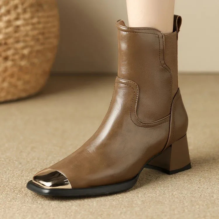 Women's brown Martin boots with high heel, side zipper, and decorative metal details on leather upper