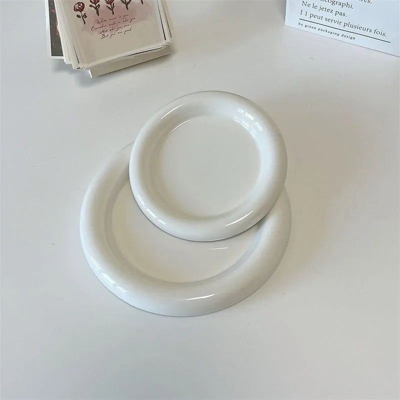 White ceramic chubby toot plate with doodle design, shown in bear and round styles.