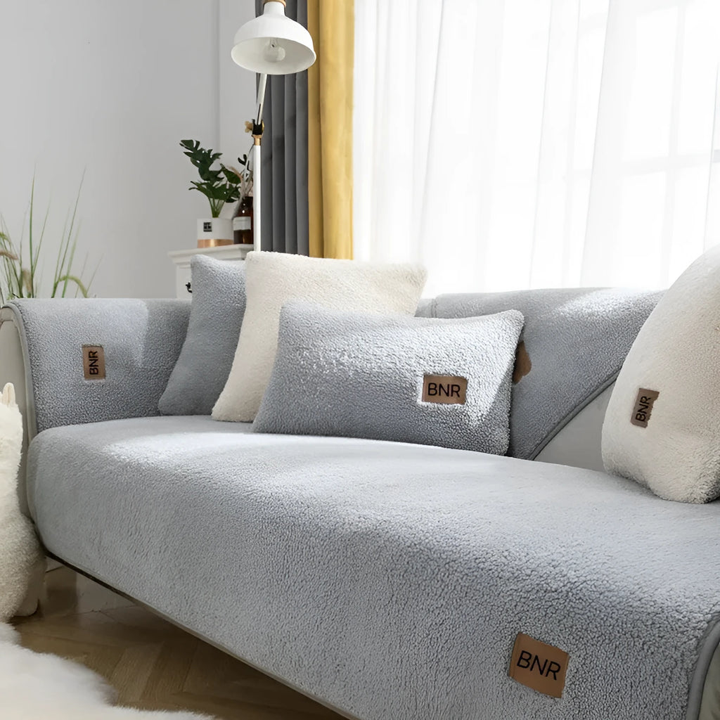 Solid colour lambswool sofa cover on a couch with matching pillow cover.