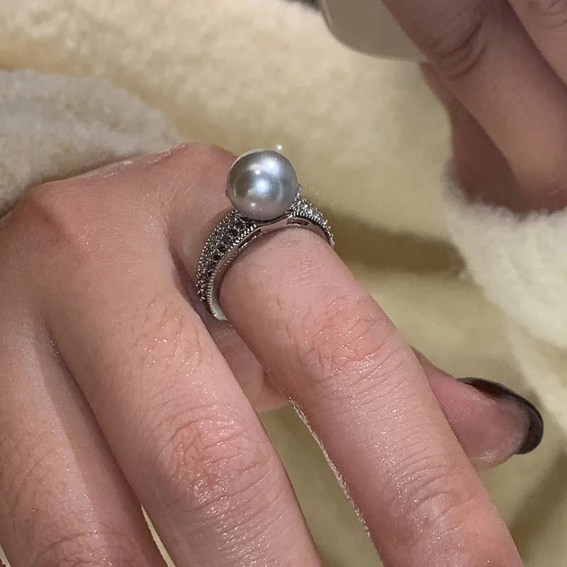 Copper geometric adjustable ring with black pearl finish on feminine hand